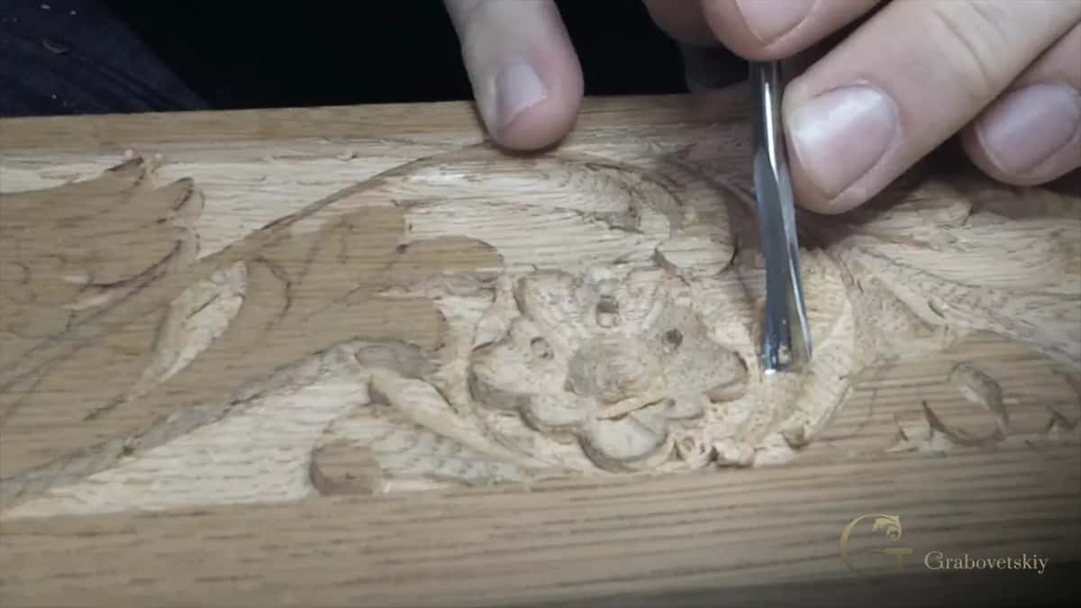 Gouge upright beside a carved flower