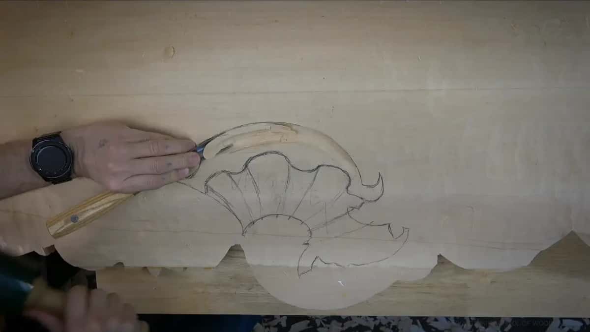 A gouge beside a drawn shell, one long curve already carved