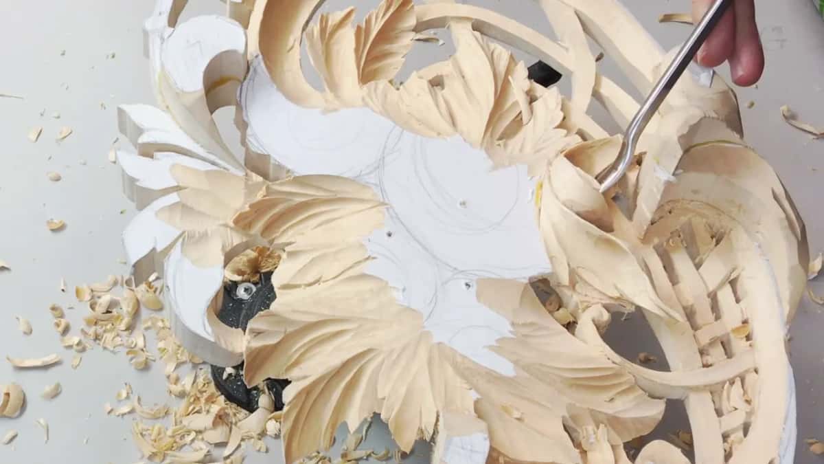 Bent steel curves down into the middle of a carved flower.