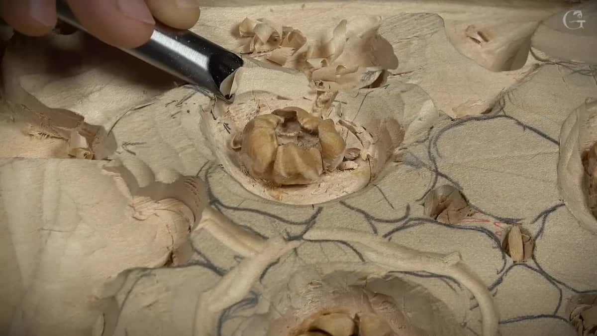 Gouge shaping an outer petal beside a darker finished center