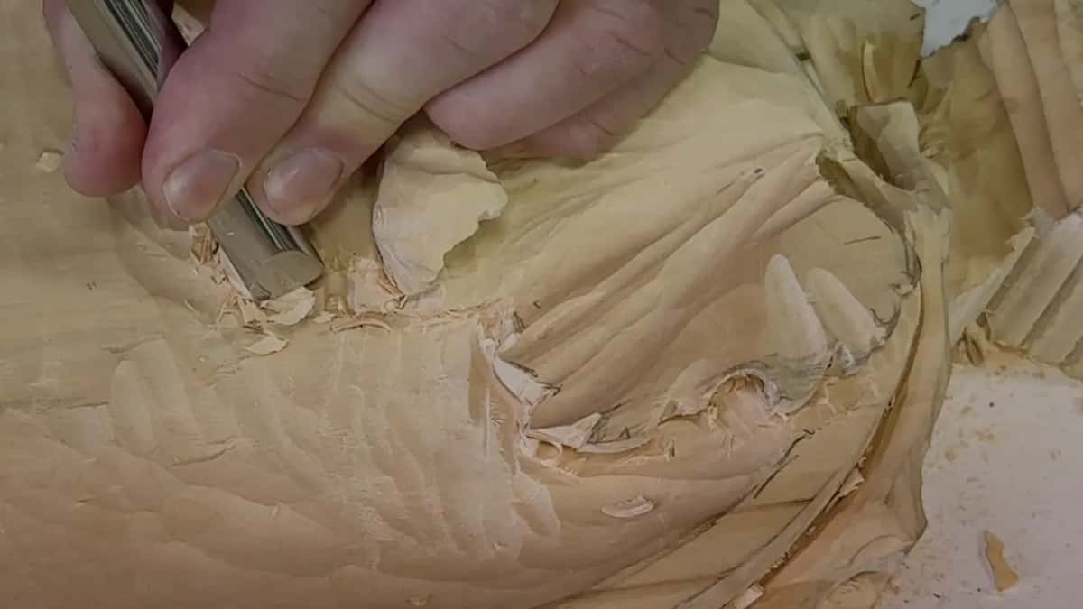 Fist around the handle, gouge digging into a curled lobe