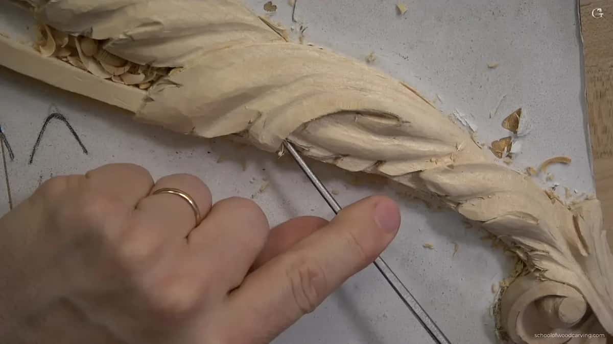Long thin tool under the acanthus scroll