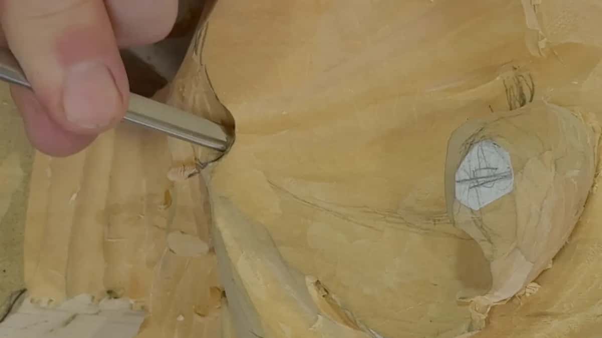 Narrow gouge deep in the excavation beside the fluted end