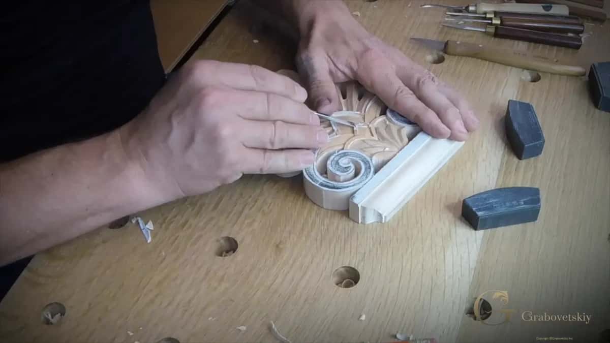 Micro tools waiting behind the block as one cleans a carved leaf