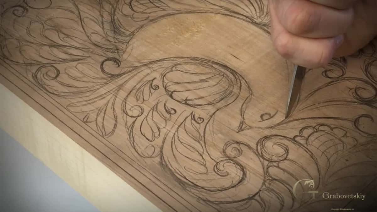 Knife held upright on the pencil outline of the bird's head, before any wood comes out