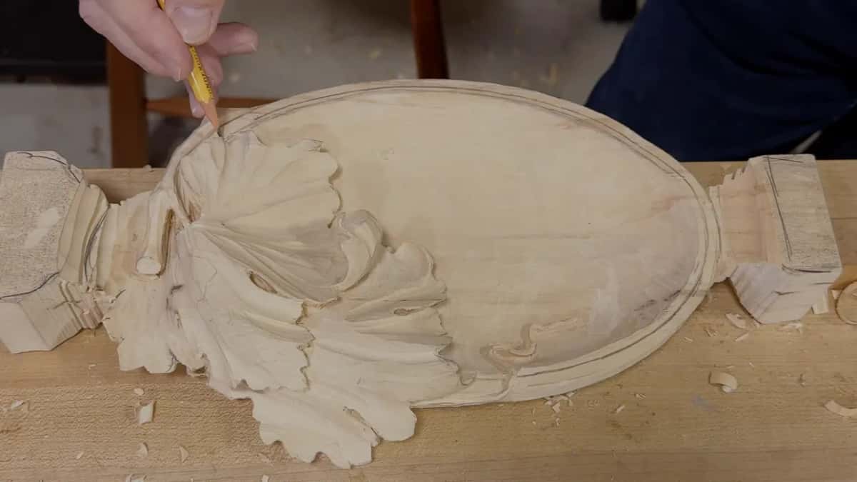 Pencil drawing a line just inside the rim, the whole leaf and both legs in view on the bench