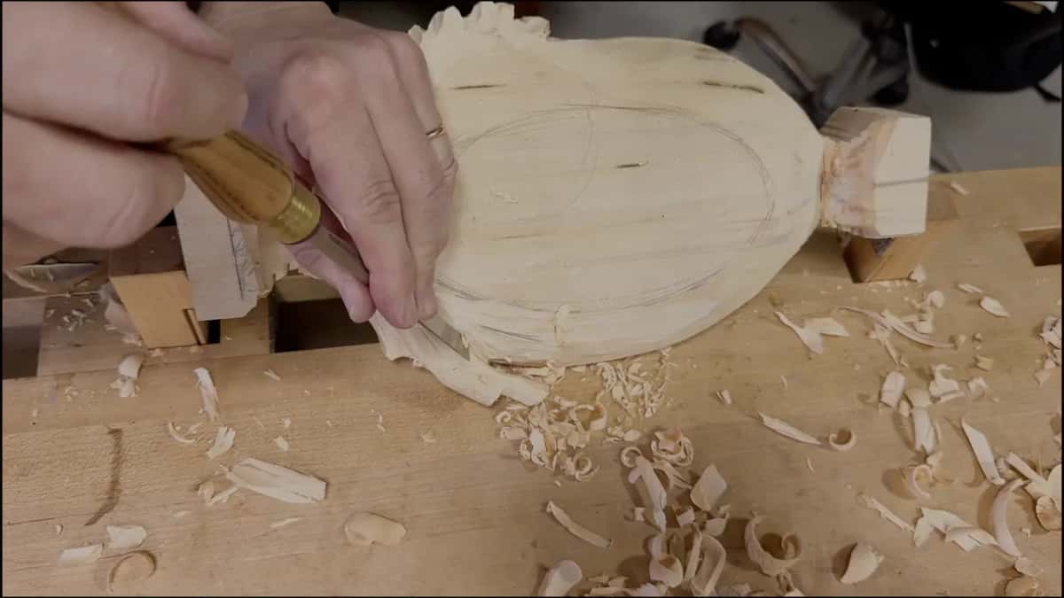 Underside of the tray with an oval drawn on its flat bottom, while a gouge works under the leaf