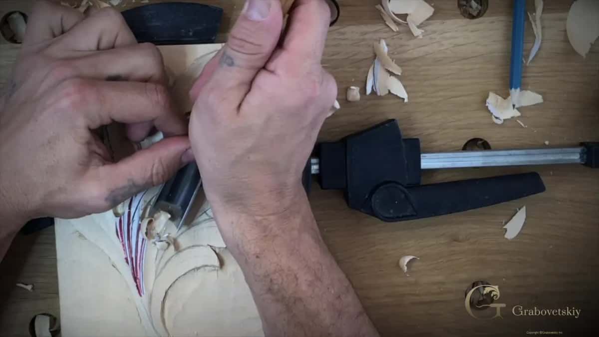 Two hands meet on one gouge