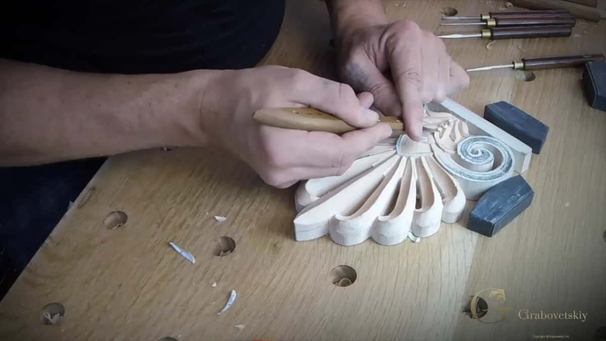 Knife pushed with both hands at the bottom of the small leaves