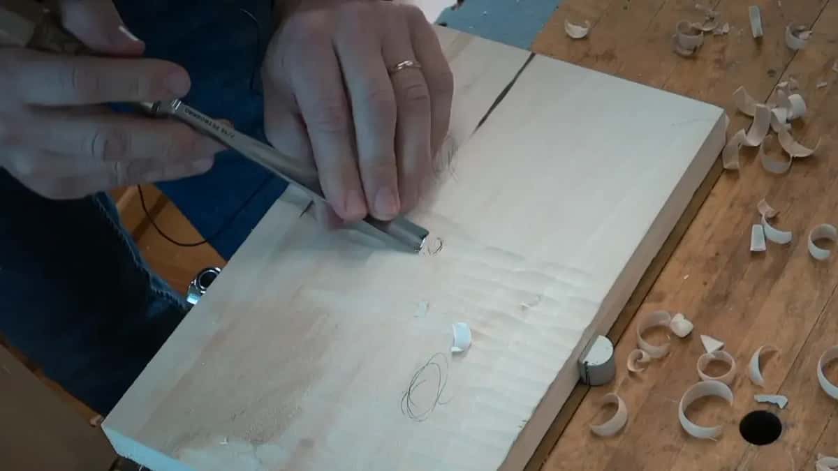 Gouge held low at the ladybug, with a pencil oval below it