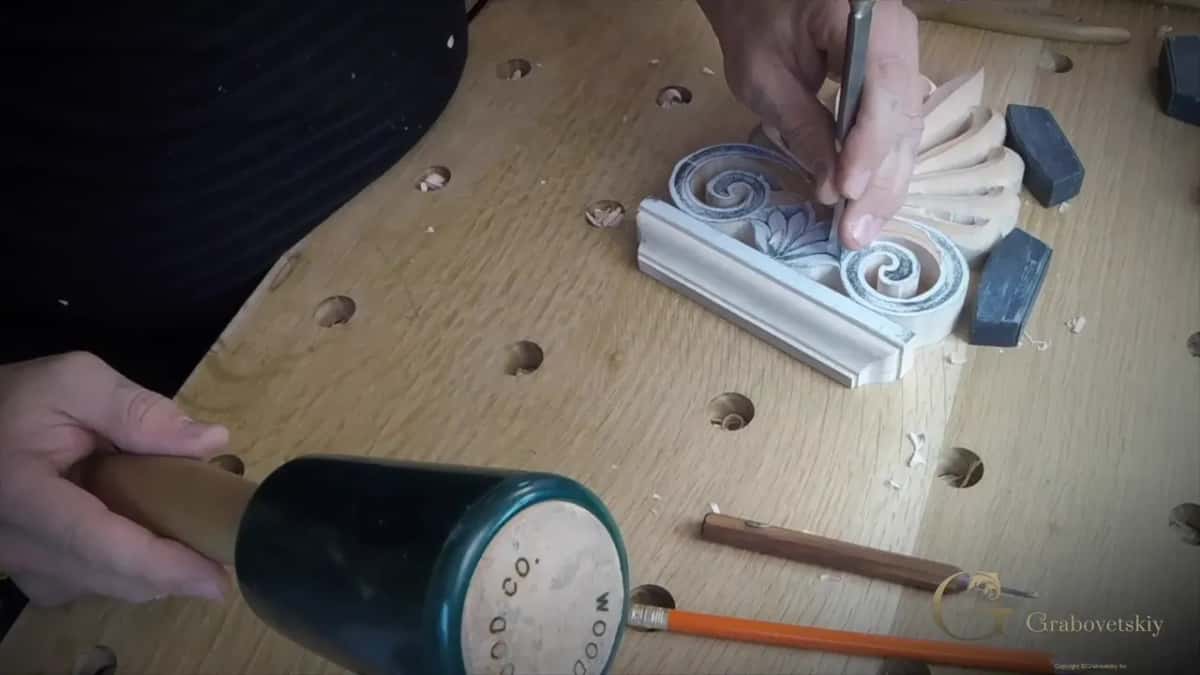 Mallet comes down on a gouge at the palmette