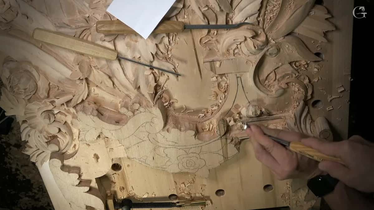 One hand runs a slim tool along the molding