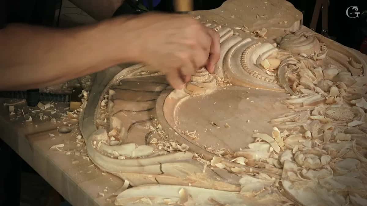 Hand pressing a tool into a deep hollow among loose chips