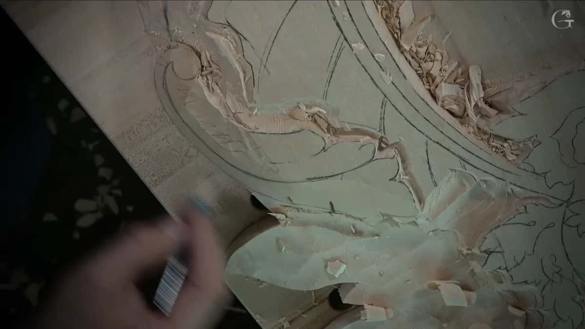 Over roughed leaves, a marker held near a volute