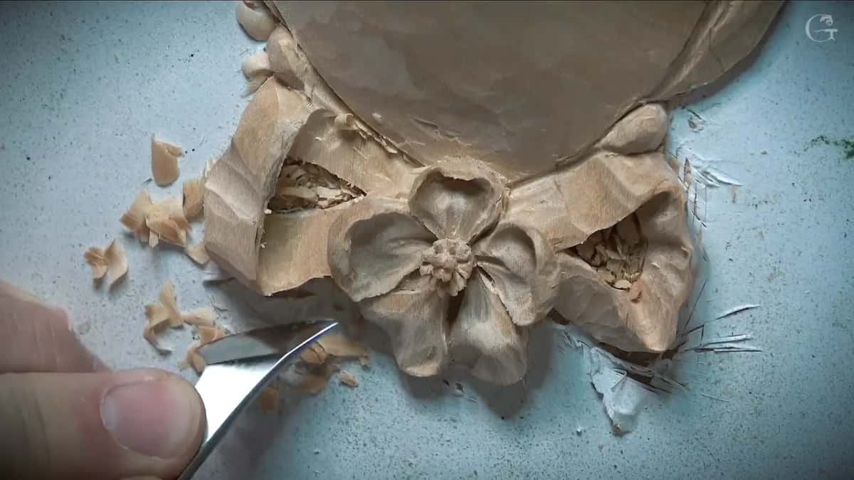 A curved blade slides in at the flower's lower left