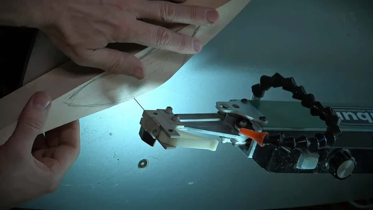 Both hands hold a thick board