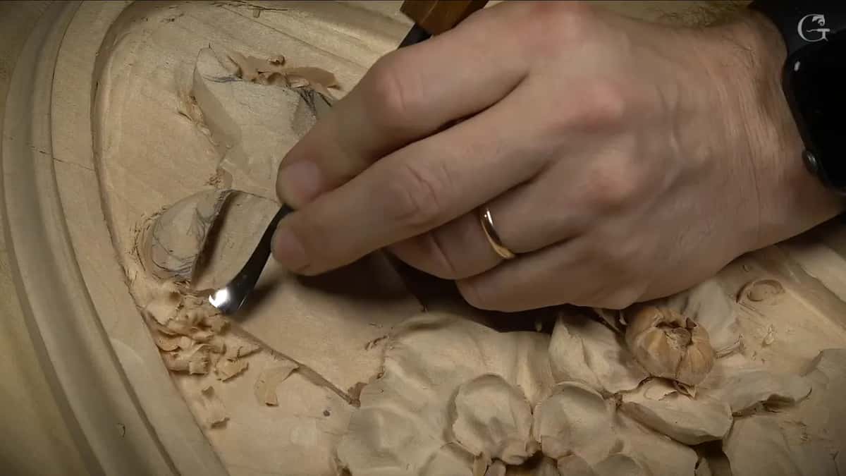 Shiny bent spoon blade scooping beside the curl