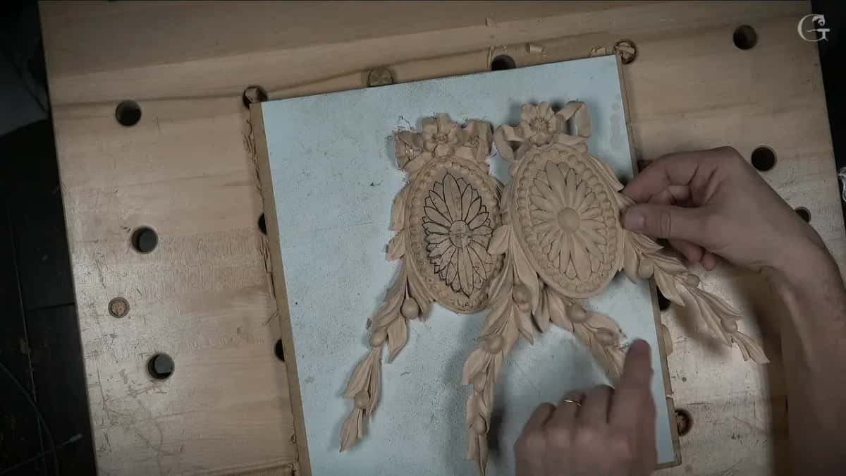 Two rosettes side by side, the left flower drawn in black lines, the right one already carved