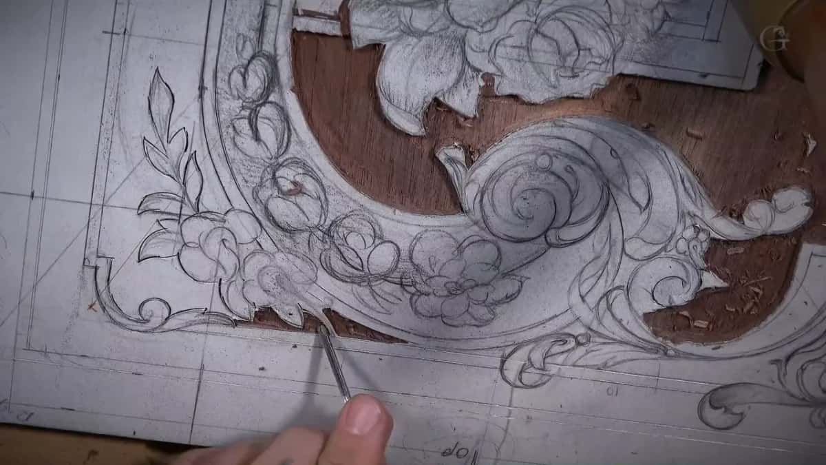 Pencil scrolls cover the panel, and a thin tool rests on one line.