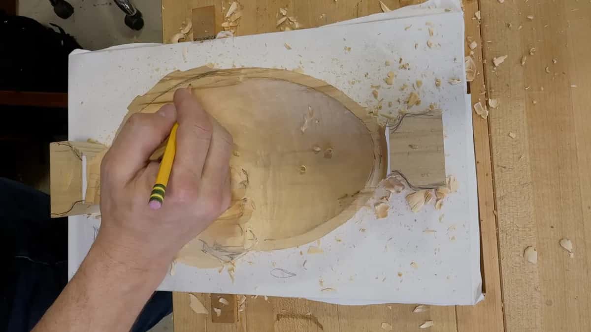 Yellow pencil redrawing the bowl's rim beside the leaf's upper corner