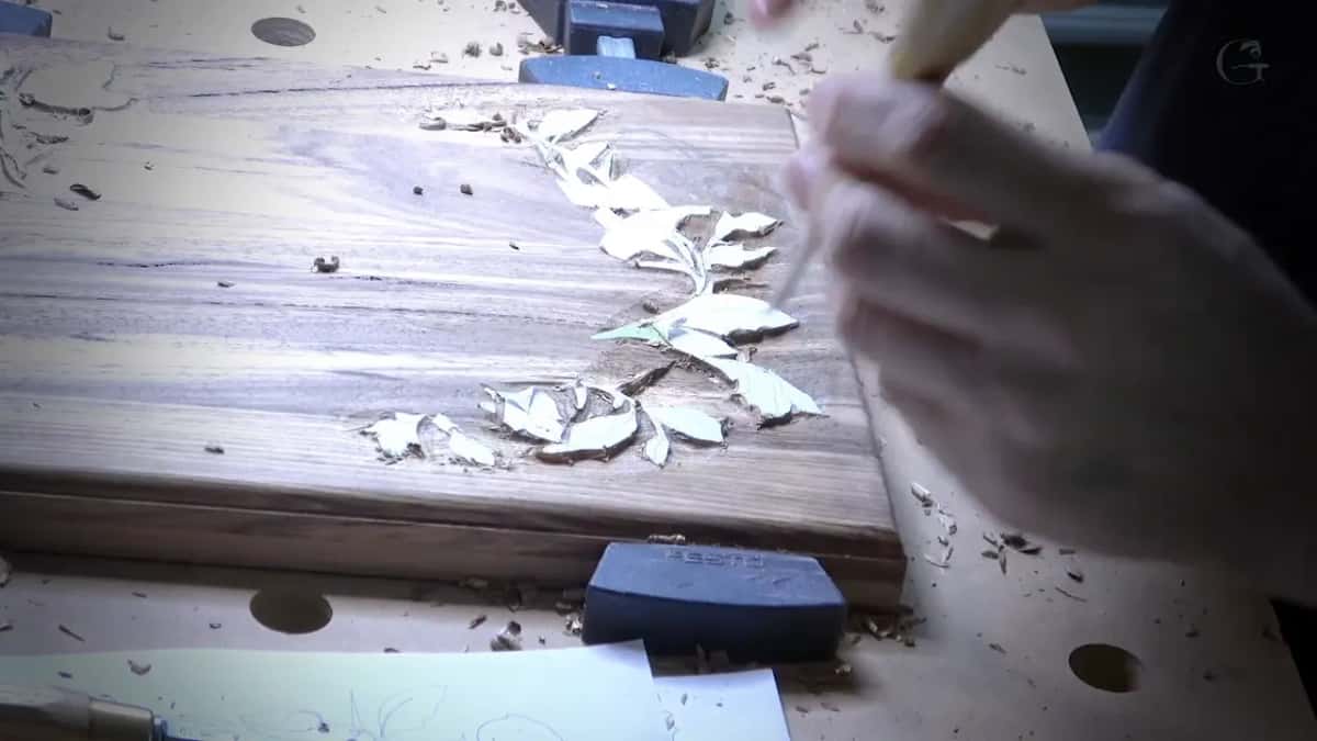 Chips of pale wood around a carved leaf